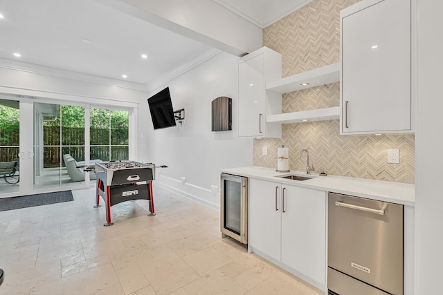 kitchen with ornamental molding, beverage cooler, sink, dishwasher, and white cabinets