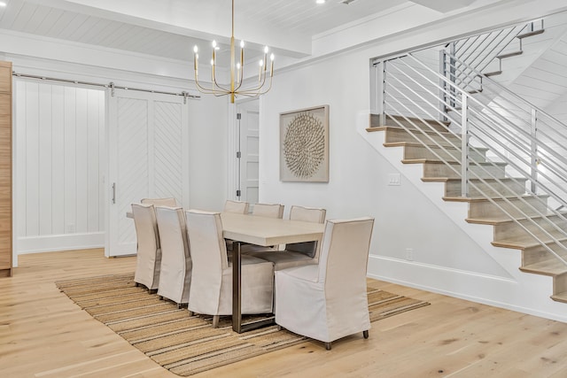 dining area featuring beamed ceiling, a barn door, wood-type flooring, and wood ceiling