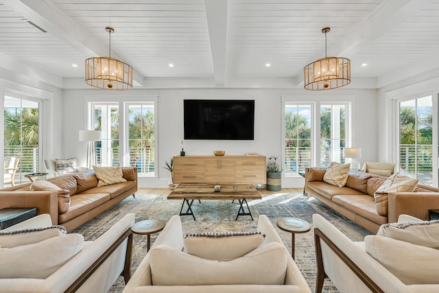 living room featuring beamed ceiling, a notable chandelier, and wood-type flooring