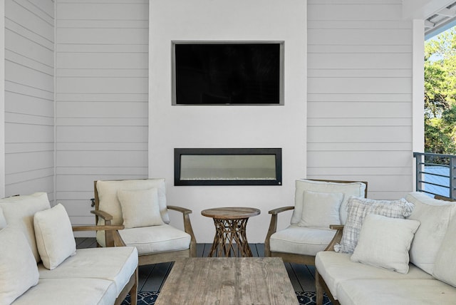 living room with wood walls and hardwood / wood-style floors