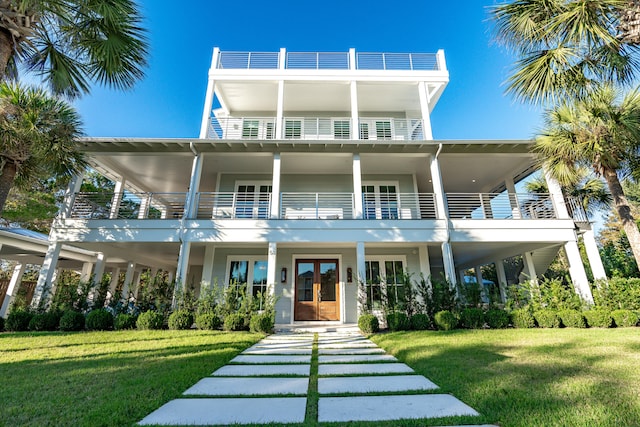 rear view of property featuring a lawn