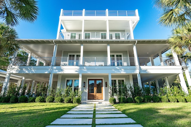 view of front of property featuring french doors and a front lawn