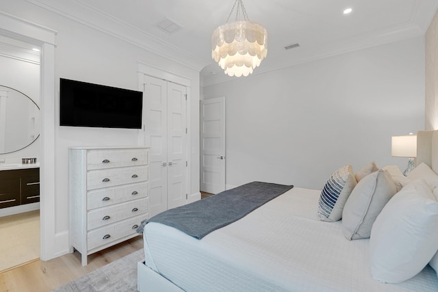 bedroom featuring a closet, ornamental molding, and light wood-type flooring