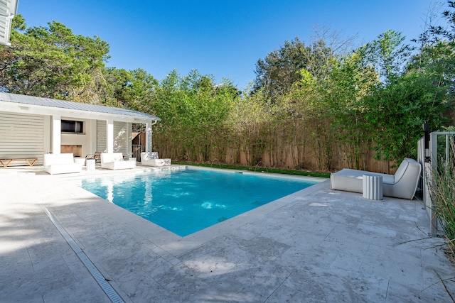 view of pool featuring an outdoor structure and a patio area