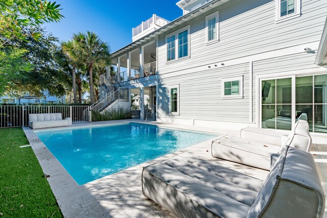 view of pool with an outdoor living space and a patio