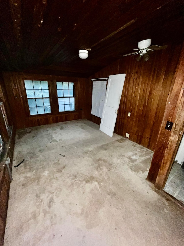 unfurnished room with wooden walls, carpet, wooden ceiling, and lofted ceiling