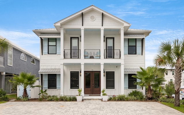 view of front of property with a balcony and french doors