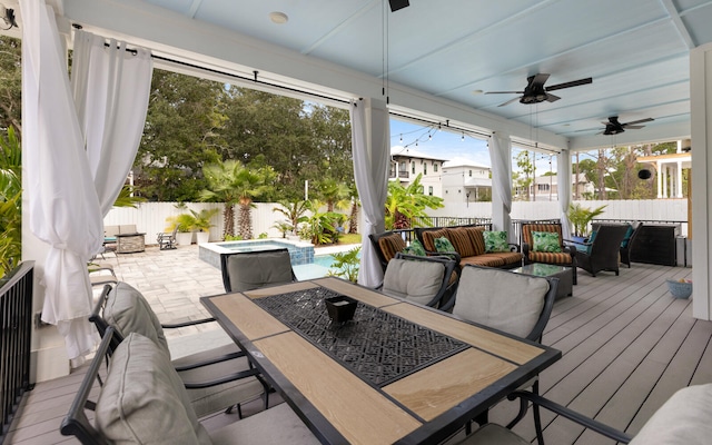 exterior space featuring an outdoor living space, a pool with hot tub, and ceiling fan