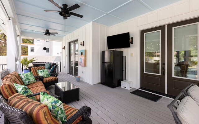 wooden deck with ceiling fan and an outdoor hangout area