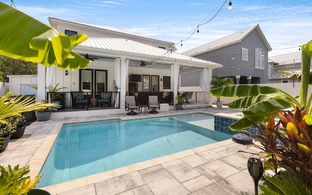 back of house with ceiling fan, a patio, and a fenced in pool