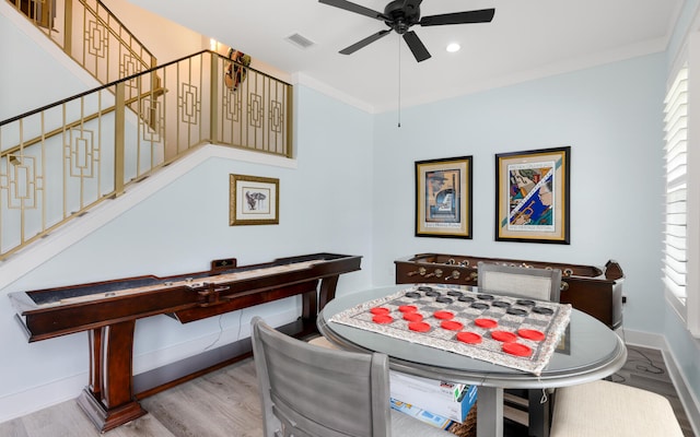 dining area featuring ceiling fan, ornamental molding, and light hardwood / wood-style flooring