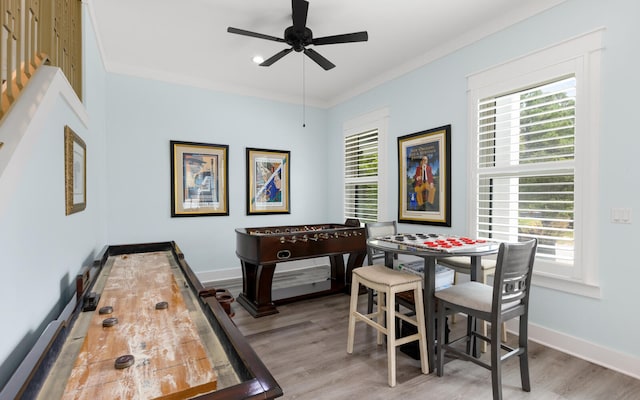 rec room with ceiling fan, hardwood / wood-style floors, and crown molding