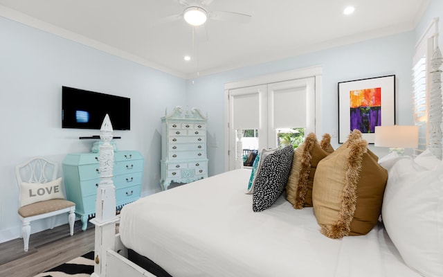 bedroom featuring ceiling fan, ornamental molding, and hardwood / wood-style flooring