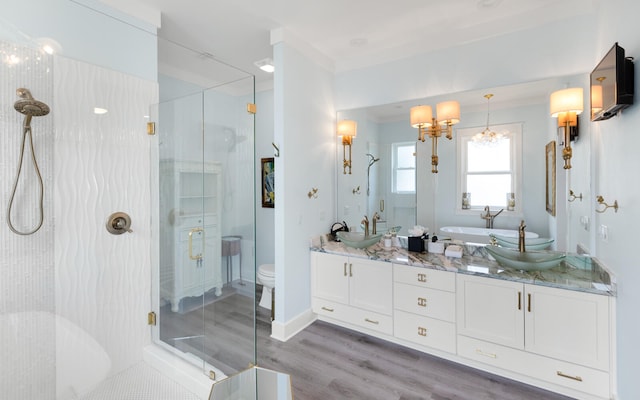 full bathroom featuring plus walk in shower, toilet, wood-type flooring, and vanity