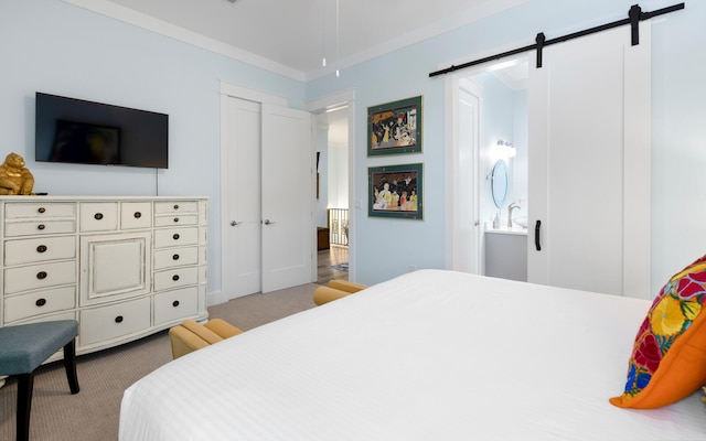 bedroom featuring light colored carpet, ornamental molding, and a barn door