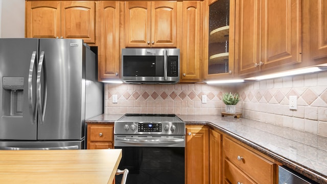 kitchen with backsplash and stainless steel appliances