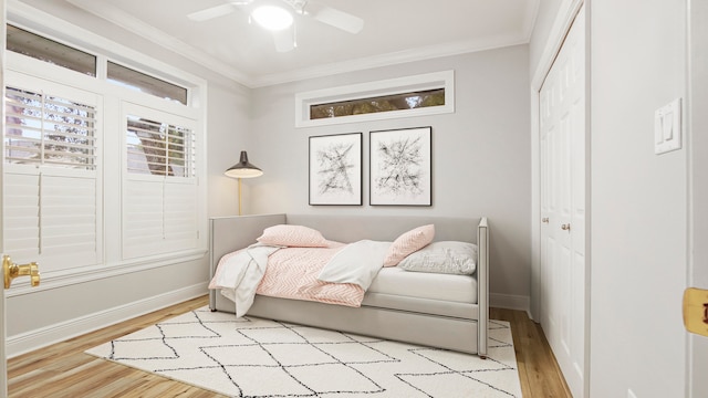 bedroom featuring ceiling fan, light hardwood / wood-style flooring, and a closet