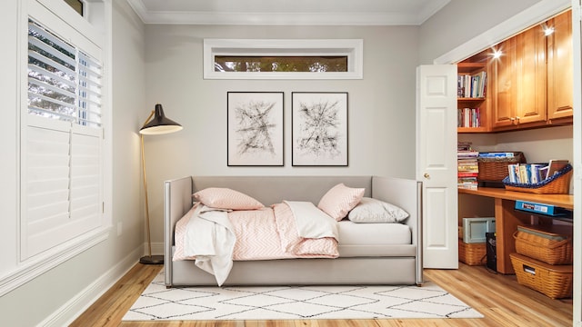 living area with light hardwood / wood-style flooring and ornamental molding