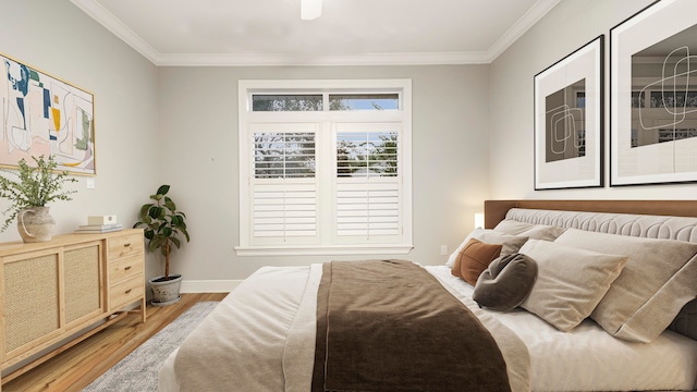 bedroom with ornamental molding and hardwood / wood-style flooring