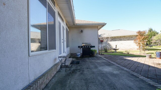 view of side of property featuring a patio