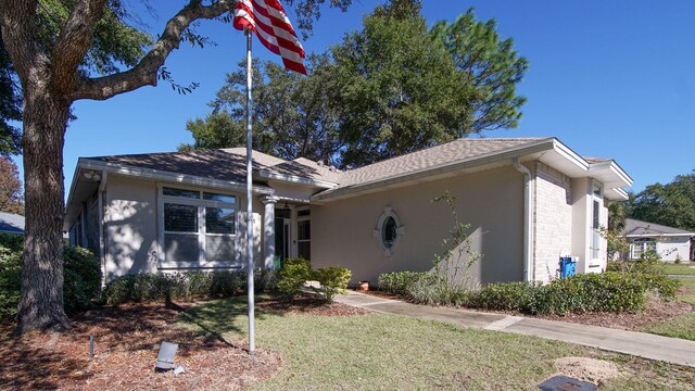 ranch-style house with a front lawn