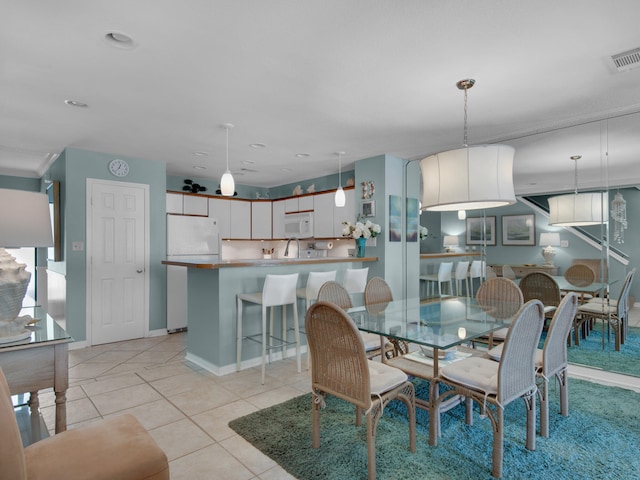 tiled dining room with sink