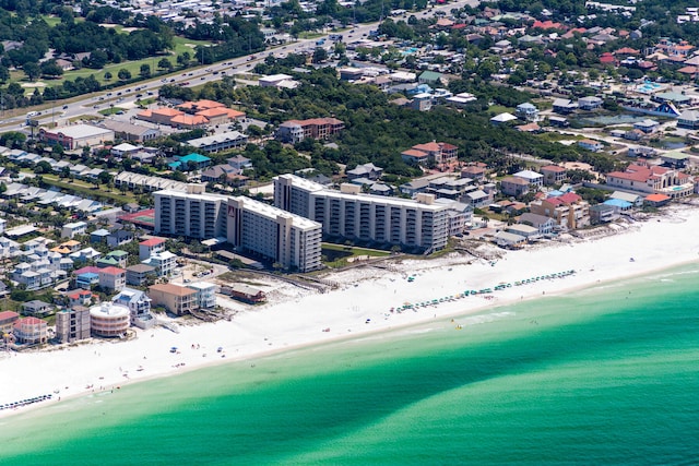 birds eye view of property with a water view and a beach view