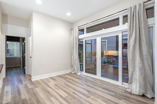 empty room with light hardwood / wood-style floors