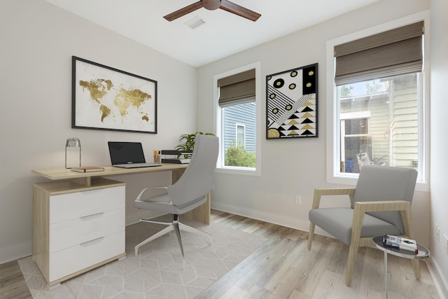 office space with ceiling fan and light hardwood / wood-style flooring