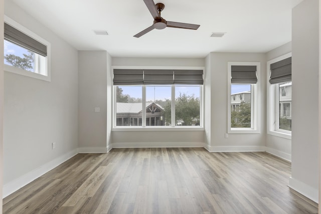 unfurnished room with ceiling fan and hardwood / wood-style flooring