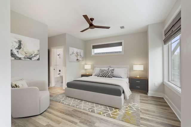 bedroom with multiple windows, ceiling fan, and light wood-type flooring