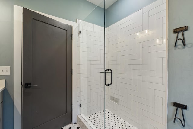 bathroom featuring a shower with shower door