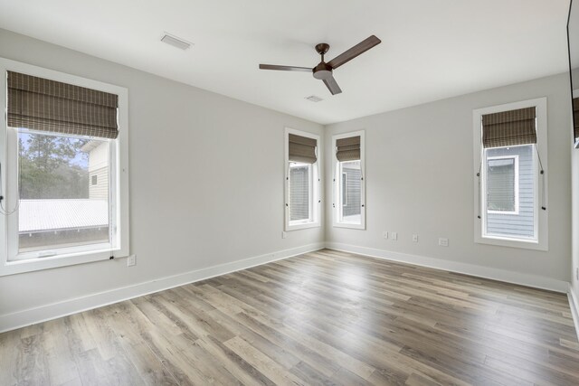 empty room with wood-type flooring and ceiling fan