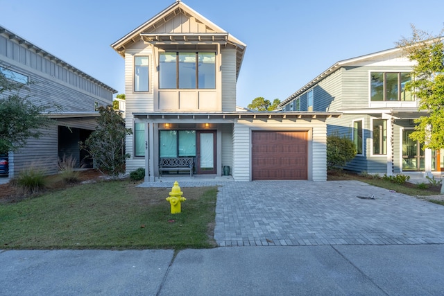 view of front of home with a garage and a front yard