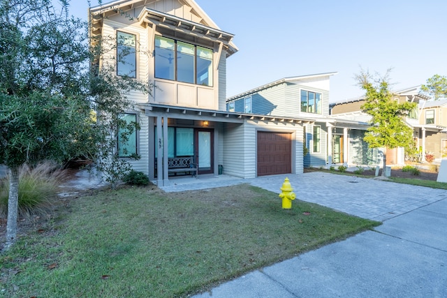 view of front facade with a garage and a front yard