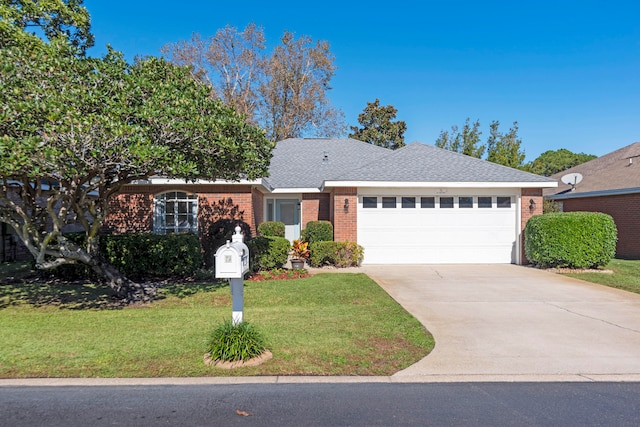 single story home with a garage and a front lawn