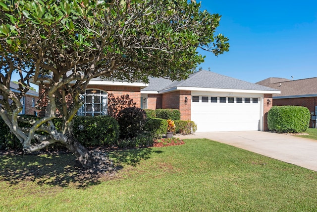 view of front of house featuring a garage and a front lawn