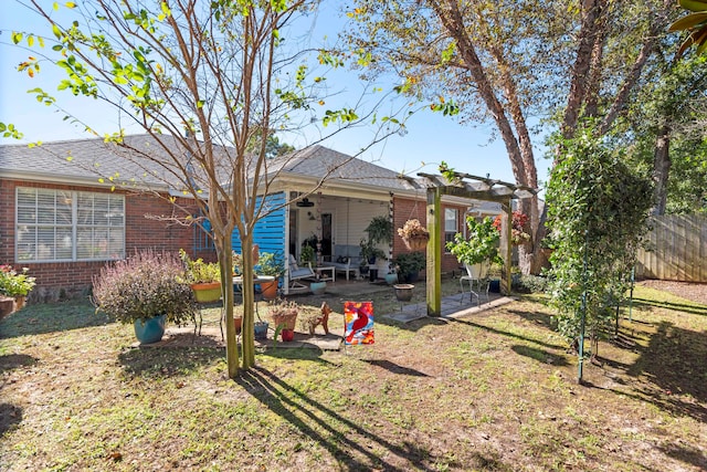 rear view of property with a yard and a patio