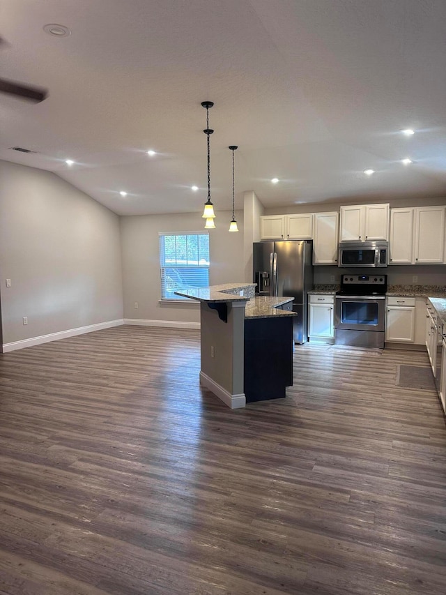 kitchen with a kitchen island, dark hardwood / wood-style flooring, and stainless steel appliances