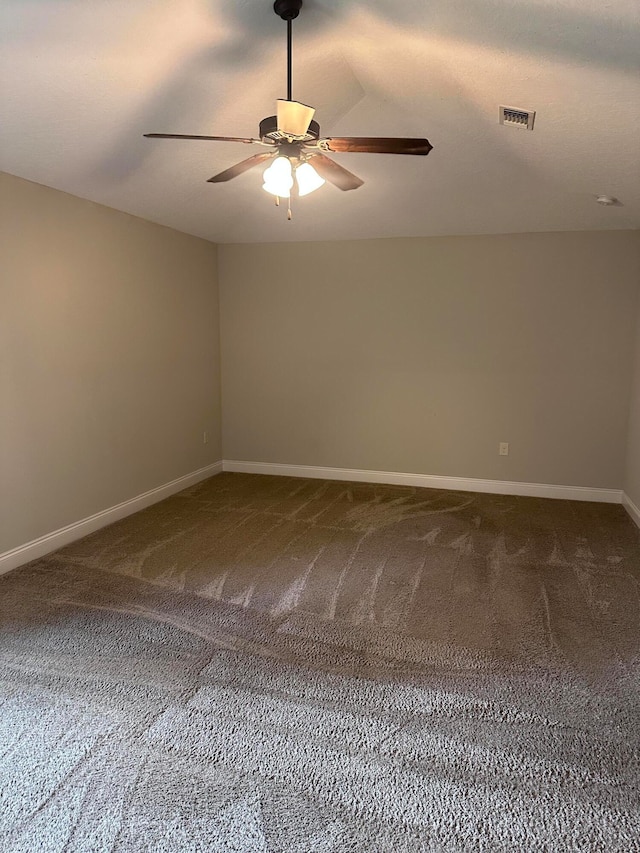 empty room with ceiling fan and carpet floors