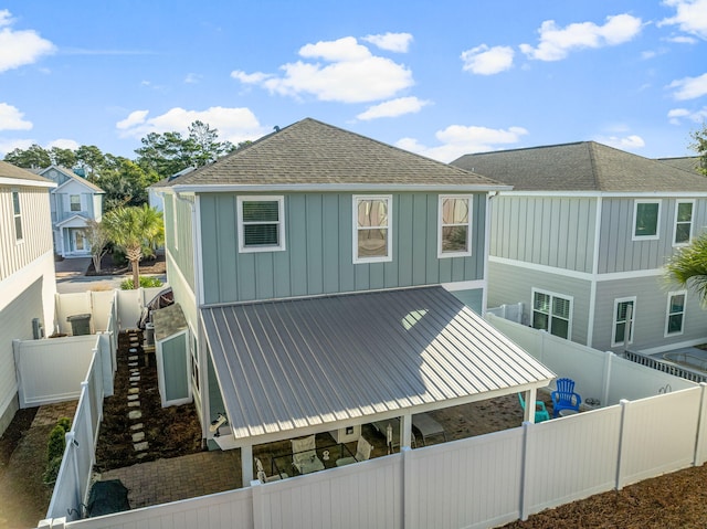 135 Grayling Way, Inlet Beach, FL 32461 - back of house with board and batten siding, a fenced backyard, and roof with shingles