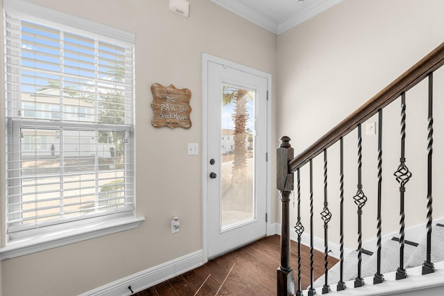 doorway to outside with crown molding and dark wood-type flooring