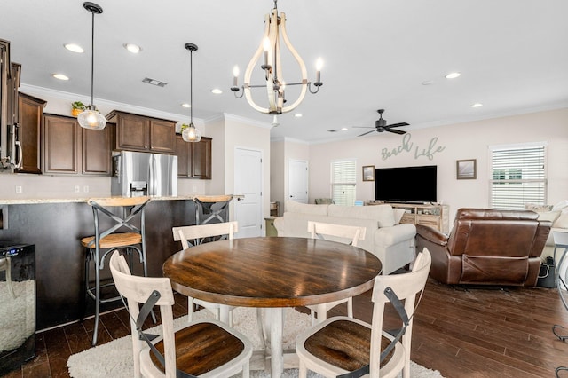 dining area with crown molding, ceiling fan with notable chandelier, and dark hardwood / wood-style floors