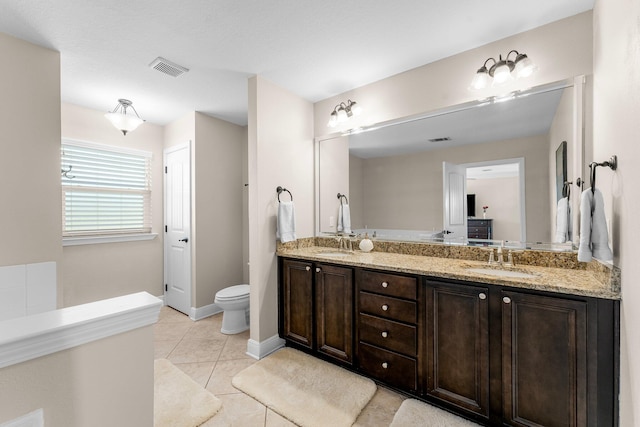 bathroom featuring tile patterned floors, vanity, and toilet