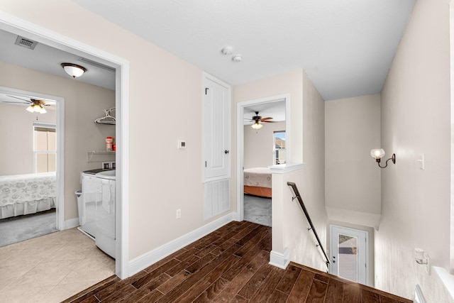 hall with washer and dryer and hardwood / wood-style flooring