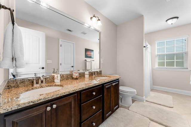 bathroom featuring tile patterned floors, vanity, and toilet