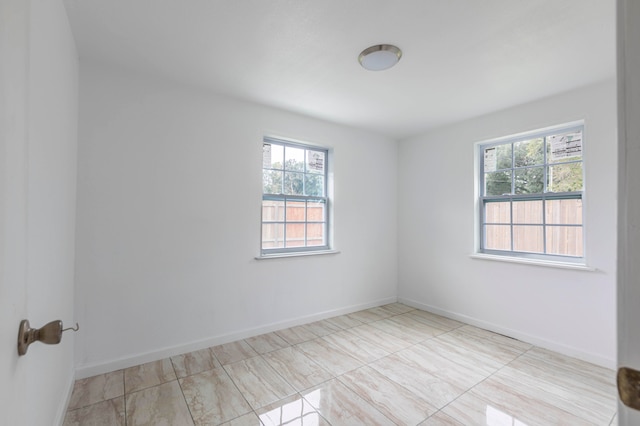 unfurnished room featuring a wealth of natural light