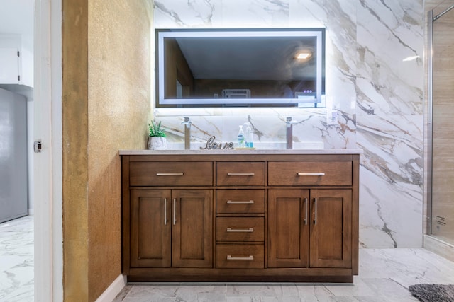 bathroom featuring vanity, a shower, and tile walls