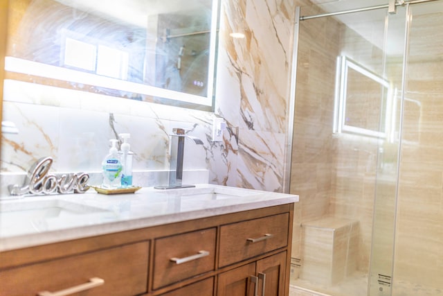 bathroom with a shower, backsplash, tile walls, and sink