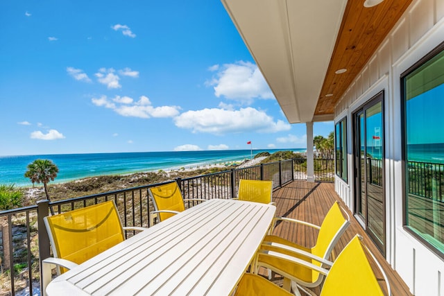 balcony featuring a view of the beach and a water view